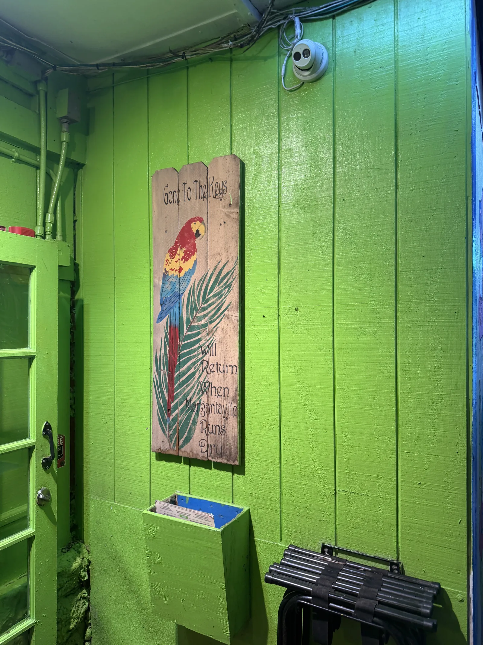 A parrot sign at Old Key Lime House reading gone to the Keys, will return when sanity runs out