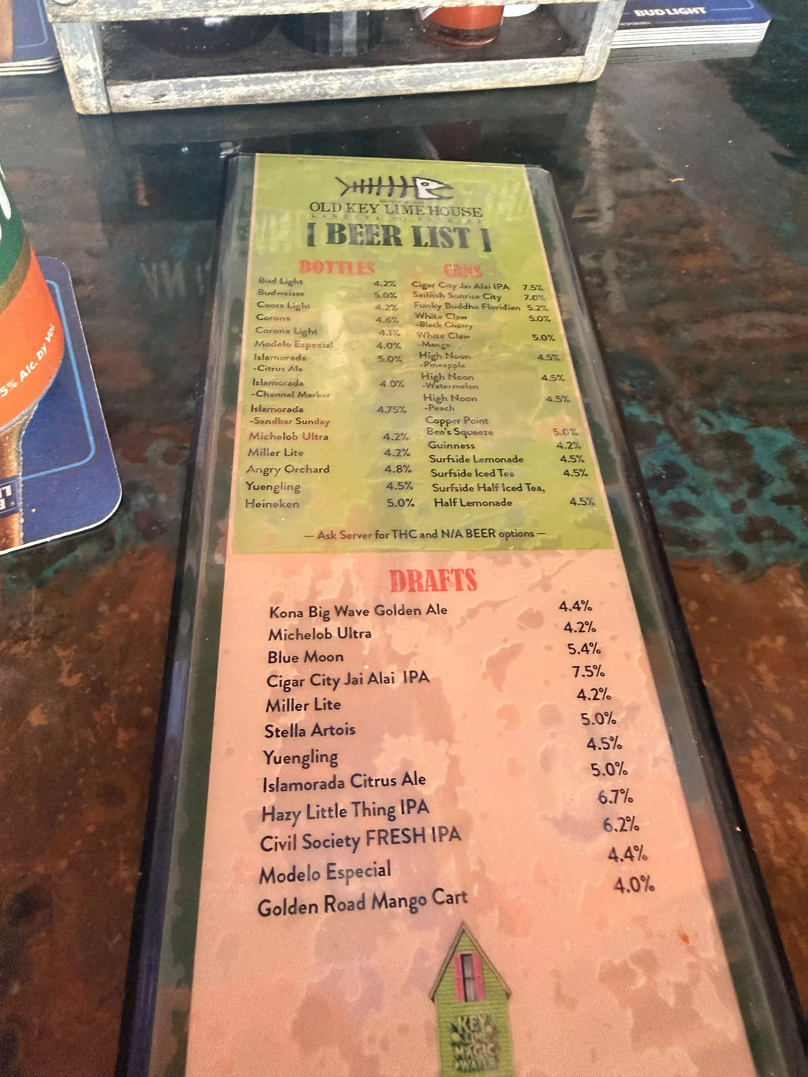 The Old Key Lime House beer list on the counter, bottled, canned and draft with percentages