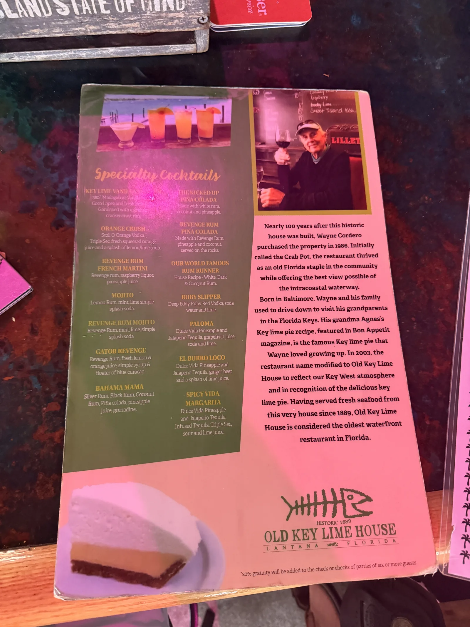 Old Key Lime House's cocktail menu with a slice of key lime pie and the restaurant's history