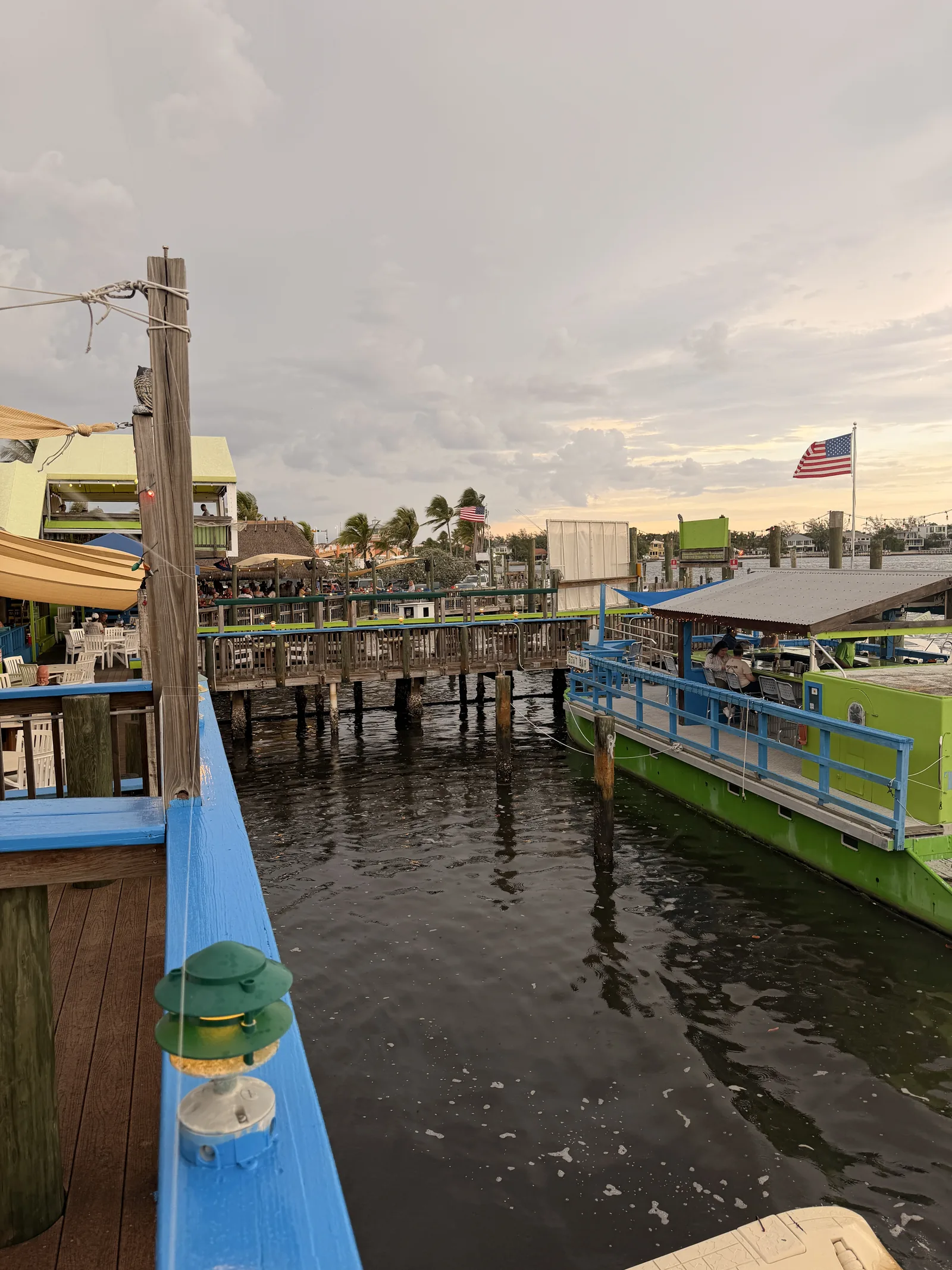 Old Key Lime House from the water, the Boat Bar docked and diners out along the piers