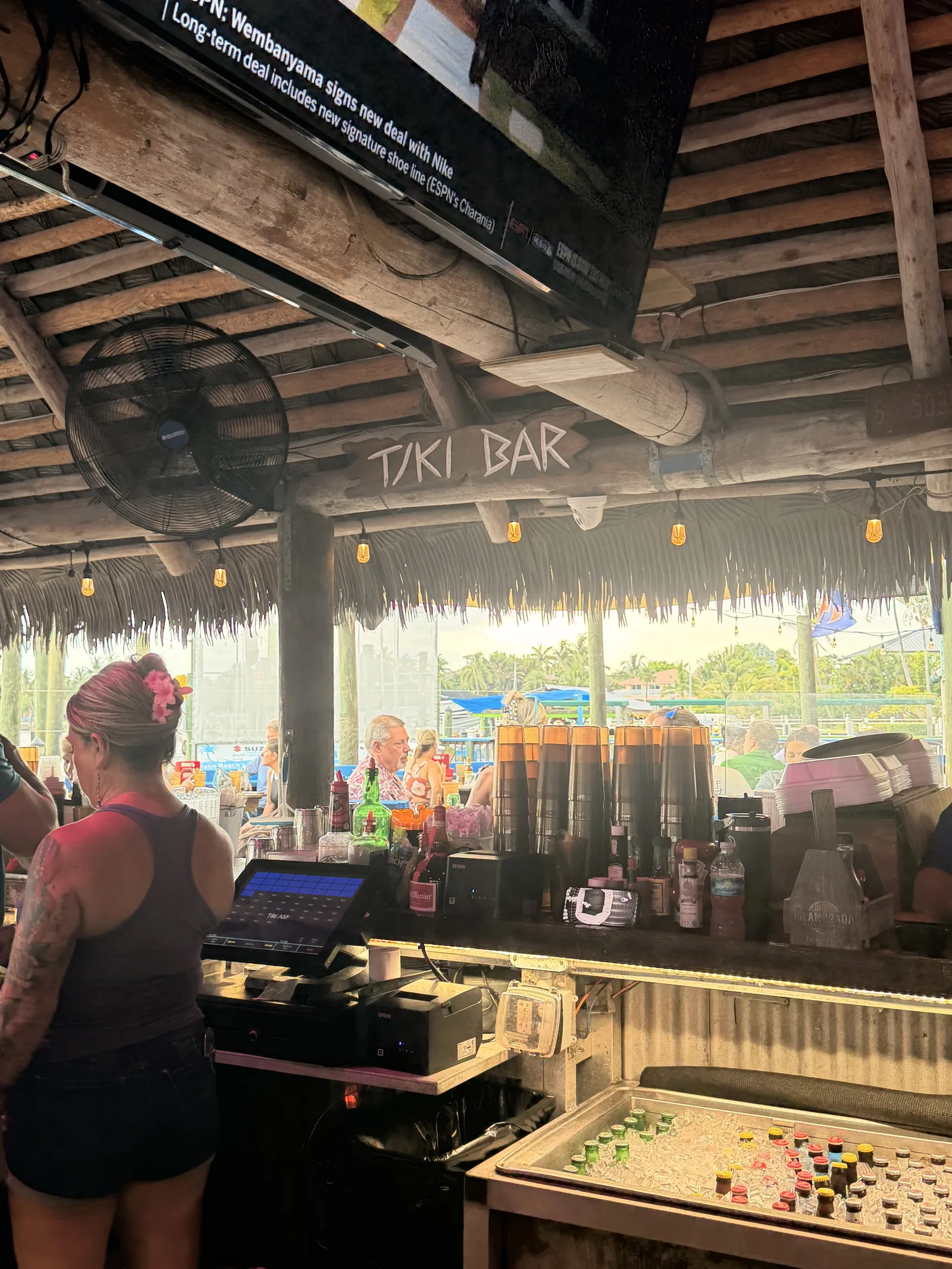 The Tiki Bar sign over the outdoor counter at Old Key Lime House, string lights along the beams